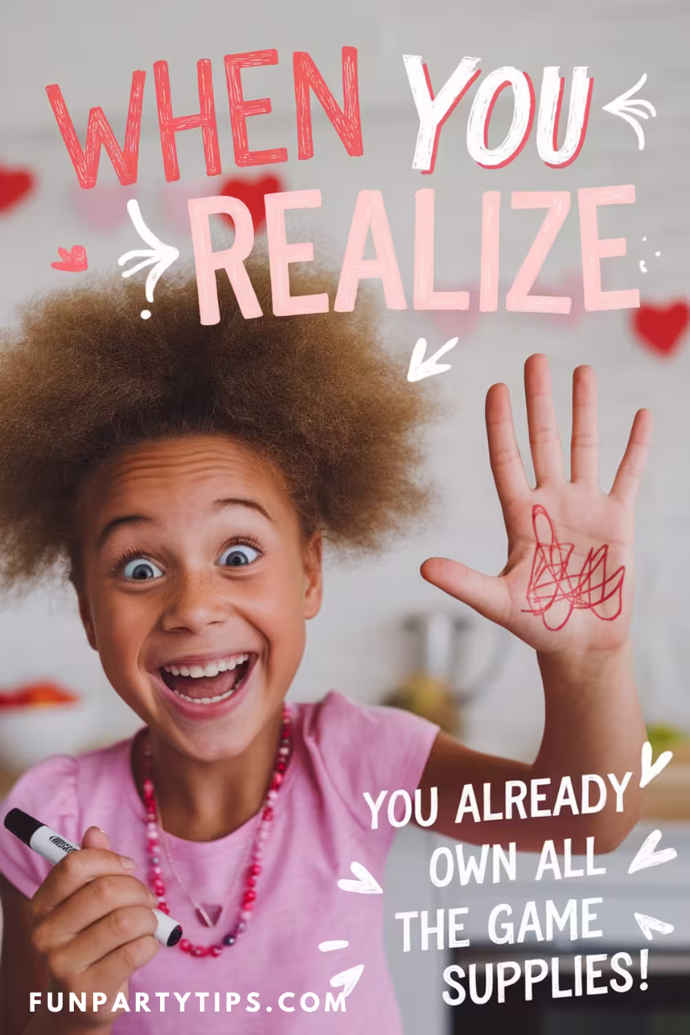 A-grinning-young-girl-holding-up-her-hand-with-playful-marker-scribbles,-alongside-the-text,-"When-you-realize-you-already-own-all-the-game-supplies!"-The-image-celebrates-the-simplicity-and-fun-of-setting-up-a-Valentine's-Day-game.